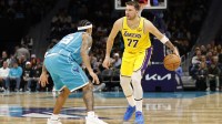 Los Angeles Lakers forward/guard Luka Doncic (77) is guarded by Charlotte Hornets guard Tre Mann (23) during the second quarter at Spectrum Center. Lakers forward/guard Luka Doncic (77) is guarded by Charlotte Hornets guard Tre Mann (23)