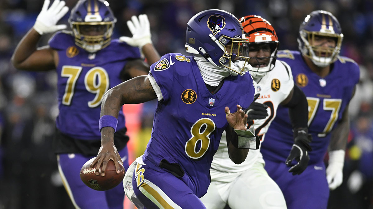 Baltimore Ravens quarterback Lamar Jackson (8) rushes thebasl against the Cincinnati Bengals during the second half at M&T Bank Stadium.