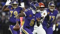Baltimore Ravens quarterback Lamar Jackson (8) rushes thebasl against the Cincinnati Bengals during the second half at M&T Bank Stadium.
