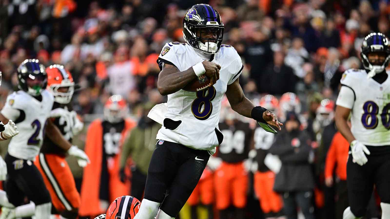 Baltimore Ravens quarterback Lamar Jackson (8) runs for a gain during the first quarter against the Cleveland Browns at Huntington Bank Field.