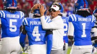 Mississippi Rebels head coach Lane Kiffin embraces linebacker Suntarine Perkins (4) during the second half against the Florida Gators at Vaught-Hemingway Stadium.