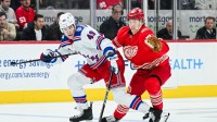 New York Rangers right wing Jaroslav Chmelar (49) brings the puck up ice against Detroit Red Wings defenseman Simon Edvinsson (77) during the third period at Little Caesars Arena.
