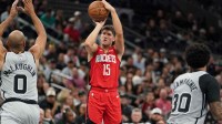 Houston Rockets guard Reed Sheppard (15) shoots against San Antonio Spurs guard Jordan McLaughin (0) during the second quarter at Frost Bank Center.