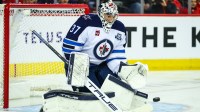 Winnipeg Jets goaltender Connor Hellebuyck (37) makes a save against the Calgary Flames during the second period at Scotiabank Saddledome.