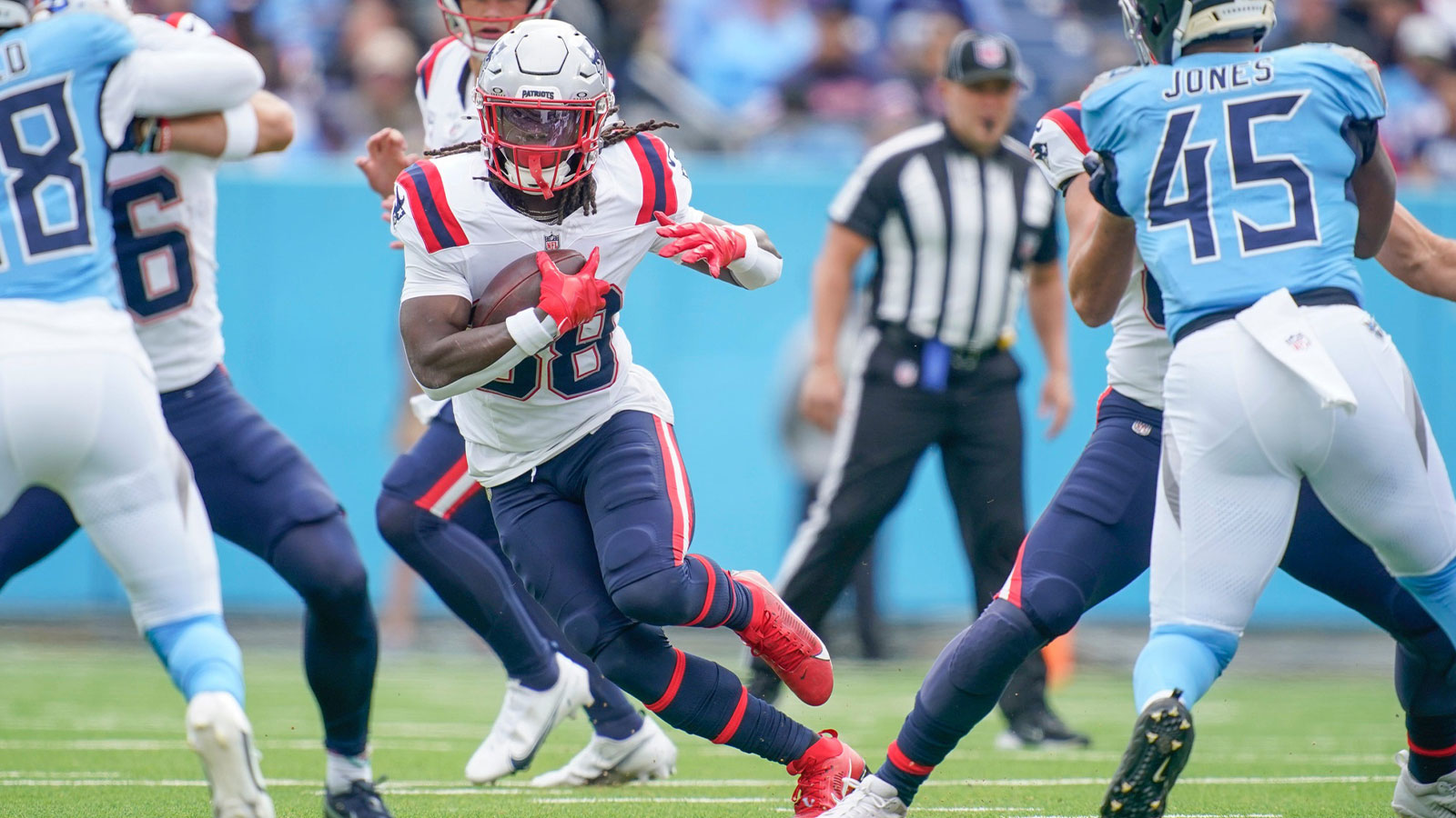 ew England Patriots running back Rhamondre Stevenson (38) runs the ball against the Tennessee Titans during the first quarter at Nissan Stadium. 