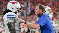 Southern Methodist Mustangs head coach Rhett Lashlee talks with Southern Methodist University offensive lineman Savion Byrd (54) on the sidelines against the Clemson Tigers during the fourth quarter at Memorial Stadium.