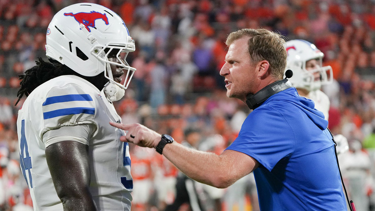 Southern Methodist Mustangs head coach Rhett Lashlee talks with Southern Methodist University offensive lineman Savion Byrd (54) on the sidelines against the Clemson Tigers during the fourth quarter at Memorial Stadium.