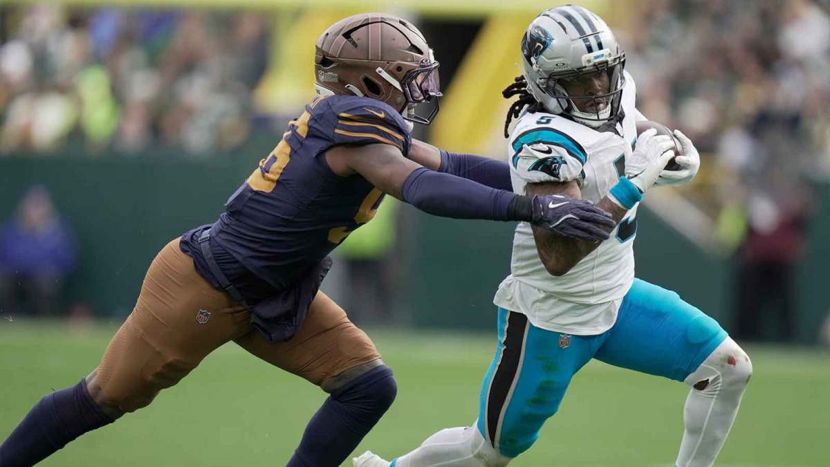 Green Bay Packers' Edgerrin Cooper (56) pursues Carolina Panthers running back Rico Dowdle (5) during the third quarter of their game.