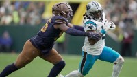Green Bay Packers' Edgerrin Cooper (56) pursues Carolina Panthers running back Rico Dowdle (5) during the third quarter of their game.