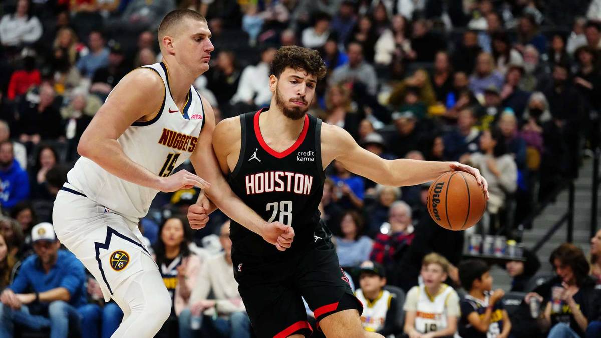 Rockets center Alperen Sengun (28) drives at Denver Nuggets center Nikola Jokic (15) in the second quarter at Ball Arena