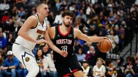Rockets center Alperen Sengun (28) drives at Denver Nuggets center Nikola Jokic (15) in the second quarter at Ball Arena