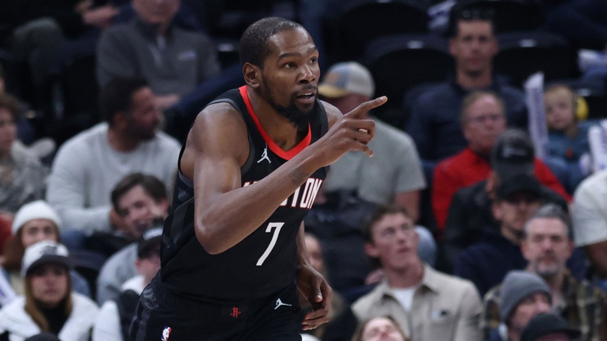 Rockets forward Kevin Durant (7) reacts to a shoot against the Utah Jazz during the second quarter at Delta Center. Mandatory Credit: Rob Gray-Imagn Images with Alex English in the background