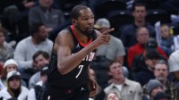 Rockets forward Kevin Durant (7) reacts to a shoot against the Utah Jazz during the second quarter at Delta Center. Mandatory Credit: Rob Gray-Imagn Images with Alex English in the background