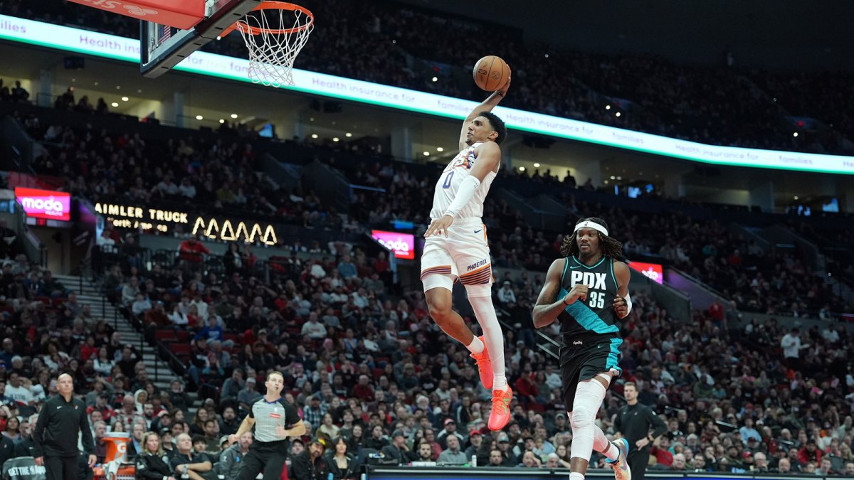 Phoenix Suns forward Ryan Dunn (0) goes up for a dunk past Portland Trail Blazers center Robert Williams III (35) during the second half at Moda Center.