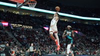 Phoenix Suns forward Ryan Dunn (0) goes up for a dunk past Portland Trail Blazers center Robert Williams III (35) during the second half at Moda Center.
