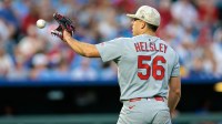 St. Louis Cardinals pitcher Ryan Helsley (56) reaches for a throw during the ninth inning against the Kansas City Royals at Kauffman Stadium.