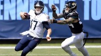 Tennessee Titans quarterback Ryan Tannehill (17) scrambles up the field away from Jacksonville Jaguars defensive end Cassius Marsh (54) at Nissan Stadium in Nashville on Sept. 20, 2020. The Titans won their home opener 33-30.