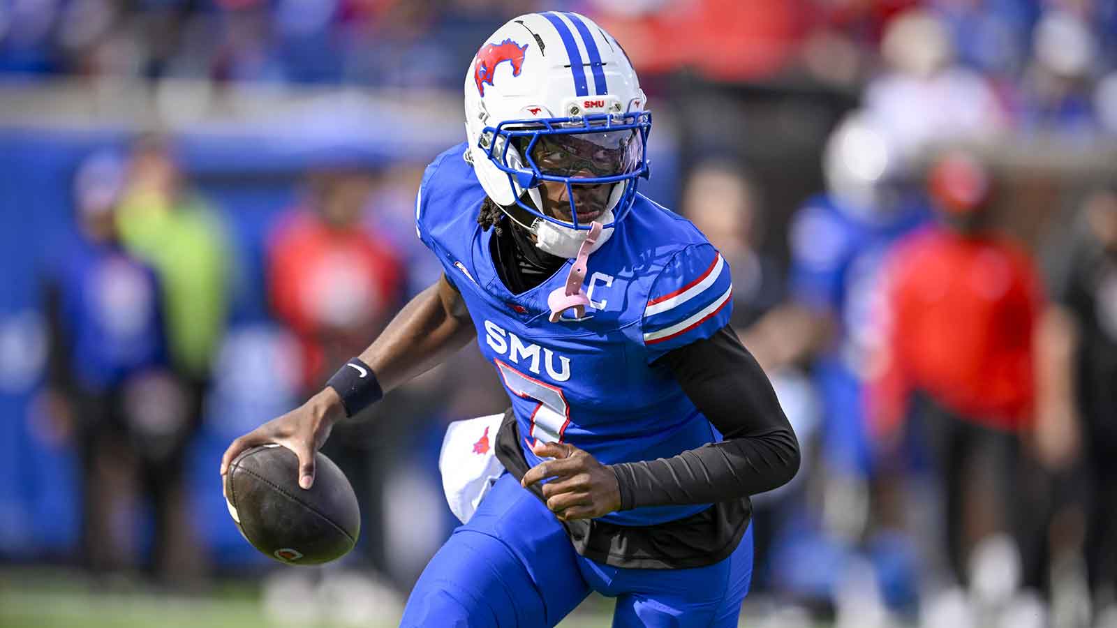 SMU Mustangs quarterback Kevin Jennings (7) runs with the ball during the first half against the Louisville Cardinals at Gerald J. Ford Stadium. 