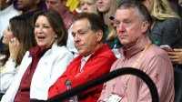 Alabama Crimson Tide Athletic Director Greg Byrne (right), former Alabama coach Nick Saban and his wife Terry Saban watch a game against the Purdue Boilermakers at Coleman Coliseum.
