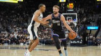 Sacramento Kings forward Domantas Sabonis (11) dribbles against San Antonio Spurs forward Jeremy Sochan (10) in the second half at Frost Bank Center.