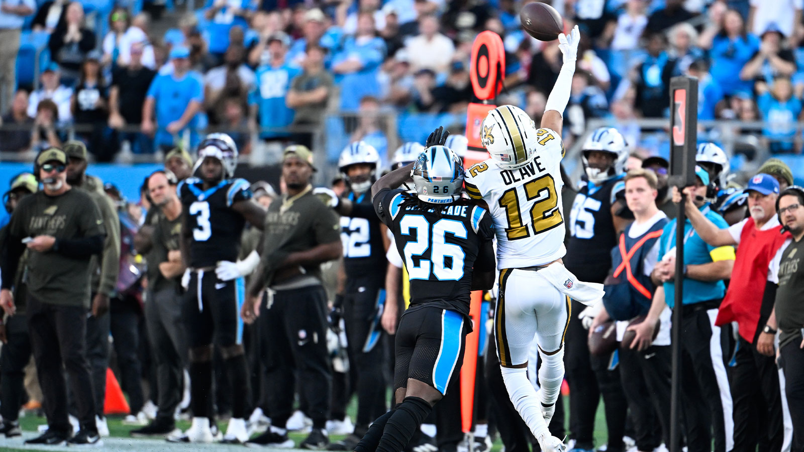 New Orleans Saints wide receiver Chris Olave (12) makes a one handed catch as Carolina Panthers cornerback Chau Smith-Wade (26) defends during the fourth quarter at Bank of America Stadium.
