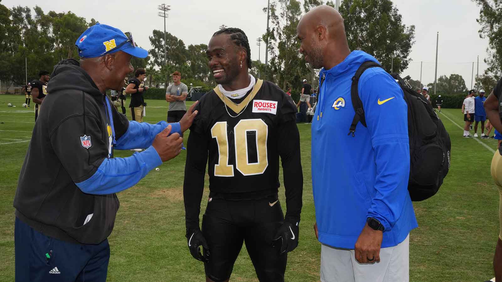 Los Angeles Rams receivers coach Eric Yarber (left) and vice president of sports medicine and performance Reggie Scott (right) talk with New Orleans Saints wide receiver Brandin Cooks (10) during a joint practice at the Dignity Health Sports Park.