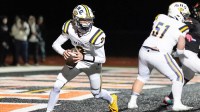 Saline quarterback Tommy Carr looks to pass against Belleville during the first half of district final at Belleville High School in Belleville on Friday, Nov. 8, 2024.