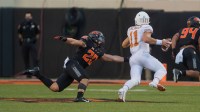Oklahoma State Cowboys linebacker Malcolm Rodriguez (20) pressures Texas Longhorns quarterback Sam Ehlinger (11) during the fourth quarter at Boone Pickens Stadium.
