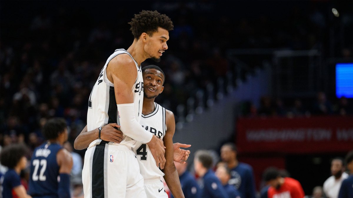 San Antonio Spurs center Victor Wembanyama (1) and guard De'Aaron Fox (4) react during the second quarter against the Washington Wizards at Capital One Arena.