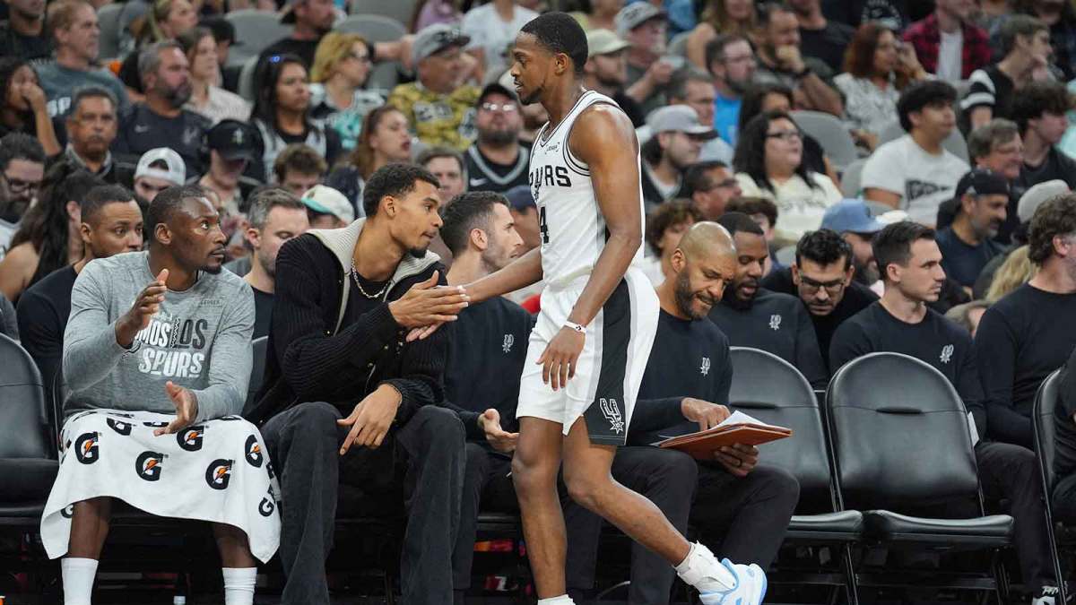 San Antonio Spurs forward Victor Wembanyama (1) greets guard De'Aaron Fox (4) in the first half at Frost Bank Center.