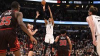 San Antonio Spurs forward Victor Wembanyama (1) makes a go-ahead three-point basket during the second half against the Chicago Bulls at the United Center.