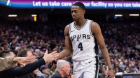 San Antonio Spurs guard De'Aaron Fox (4) high fives team mates after coming out of the game during the fourth quarter at Golden 1 Center.