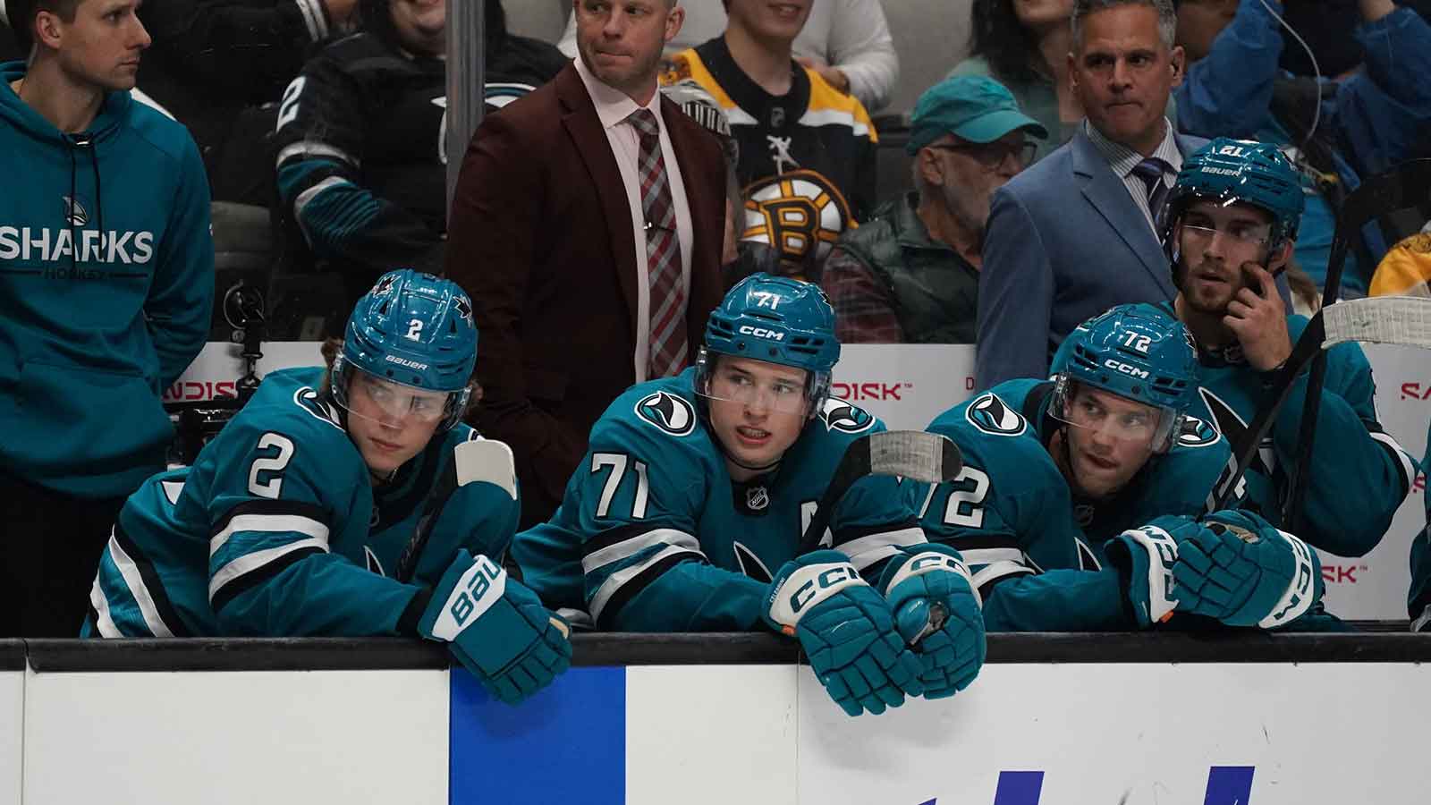 San Jose Sharks center Macklin Celebrini (71) returns to the bench after scoring a goal and sits with and center Will Smith (2), left wing William Eklund (72), and center Alexander Wennberg (21) in a game against the Boston Bruins in the second period at SAP Center in San Jose.