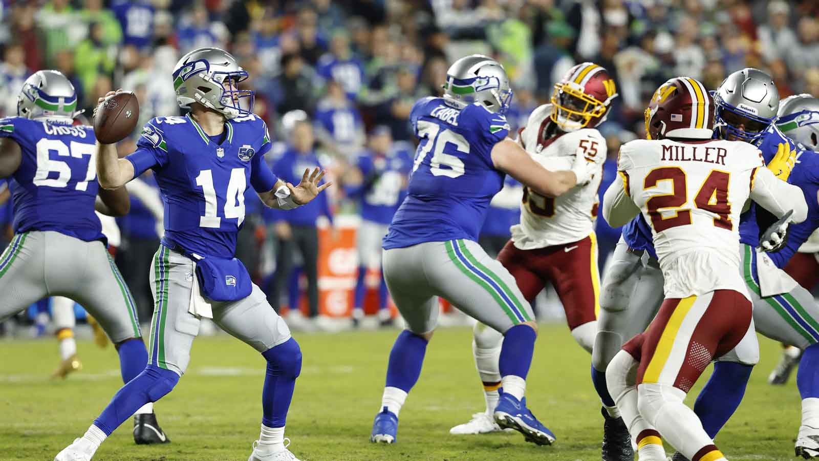 Seattle Seahawks quarterback Sam Darnold (14) looks to pass during the second quarter against the Washington Commanders at Northwest Stadium.