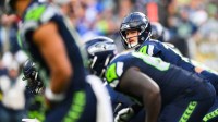 Seattle Seahawks quarterback Sam Darnold (14) prepares to take a snap during the third quarter against the Arizona Cardinals at Lumen Field.