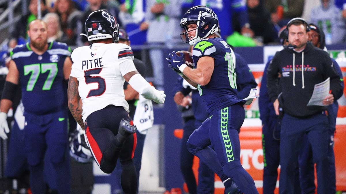 Seattle Seahawks wide receiver Cooper Kupp (10) runs after a catch against Houston Texans safety Jalen Pitre (5) during the first quarter at Lumen Field.