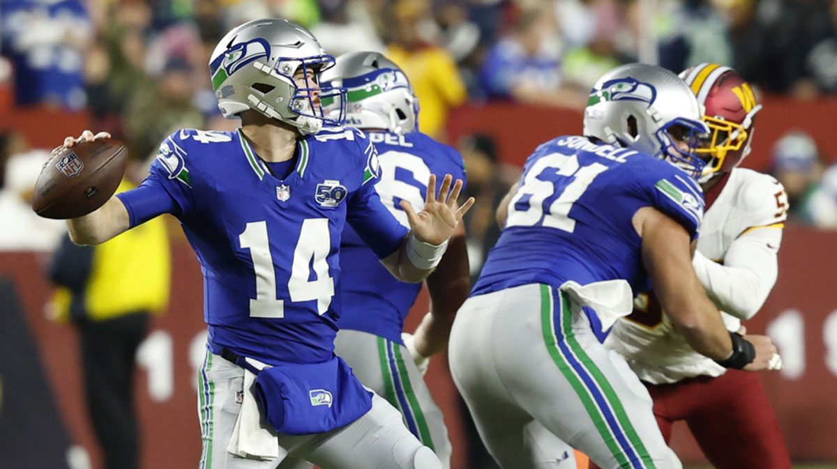 Seattle Seahawks quarterback Sam Darnold (14) looks to pass during the second quarter against the Washington Commanders at Northwest Stadium.