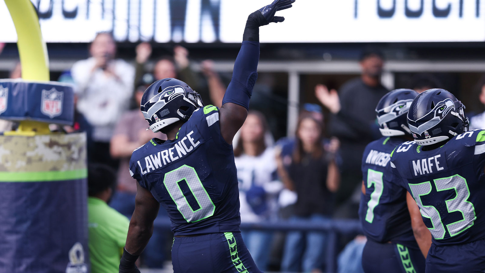 Seattle Seahawks defensive end DeMarcus Lawrence (0) celebrates after recovering a fumble to score a touchdown during the second quarter against the Arizona Cardinals at Lumen Field.