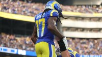 Los Angeles Rams wide receiver Davante Adams (17) is lifted up by Los Angeles Rams center Coleman Shelton (65) after scoring a touchdown New Orleans Saints during the second half at SoFi Stadium.