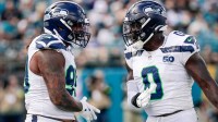 Seattle Seahawks defensive end Leonard Williams (99) and linebacker DeMarcus Lawrence (0) celebrate after a play against the Jacksonville Jaguars at EverBank Stadium.