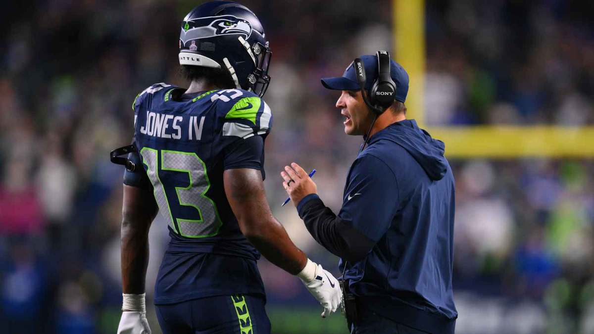 Seattle Seahawks linebacker Ernest Jones IV (13) talks with Seattle Seahawks head coach Mike Macdonald during the fourth quarter against the Houston Texans at Lumen Field.