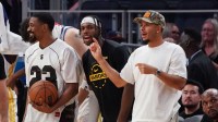 Golden State Warriors guard De'Anthony Melton (8), guard Buddy Hield (7), and guard Seth Curry (31) cheer from the bench during a game against the Los Angeles Lakers in the fourth quarter at Chase Center.