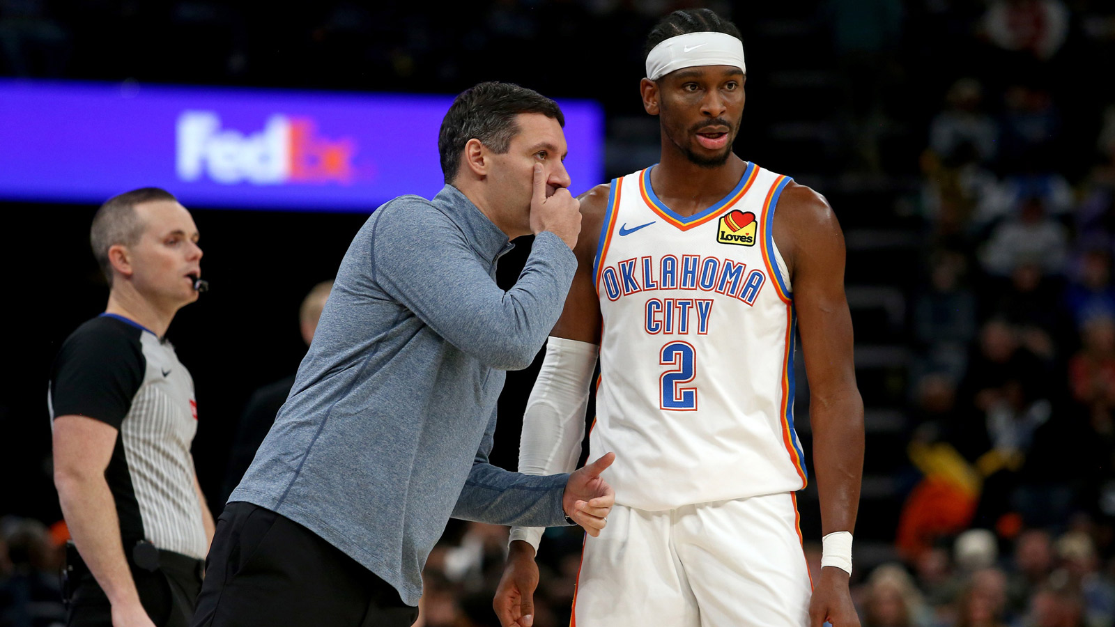 Oklahoma City Thunder head coach Mark Daigneault talks with guard Shai Gilgeous-Alexander (2) during the third quarter against the Memphis Grizzlies at FedExForum. 