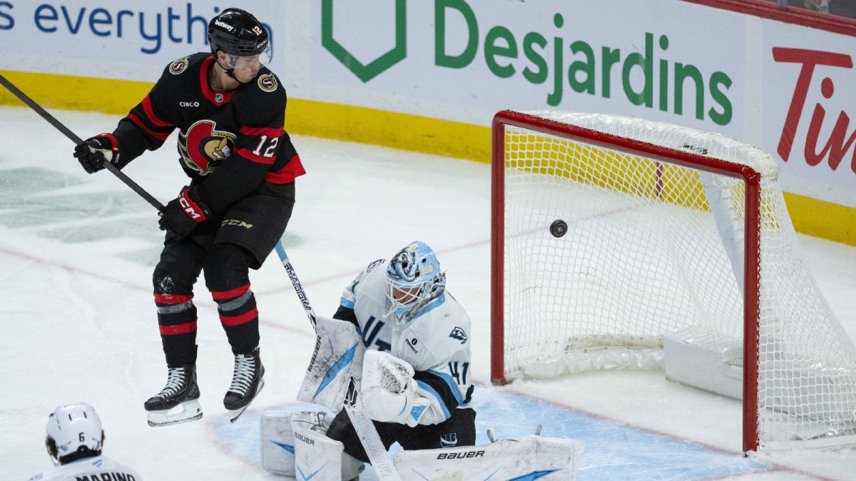 Utah Mammoth goalie Vitek Vanacek (41) blocks a shot that was screened by Ottawa Senators center Shane Pinto (12) in the third period at the Canadian Tire Centre.