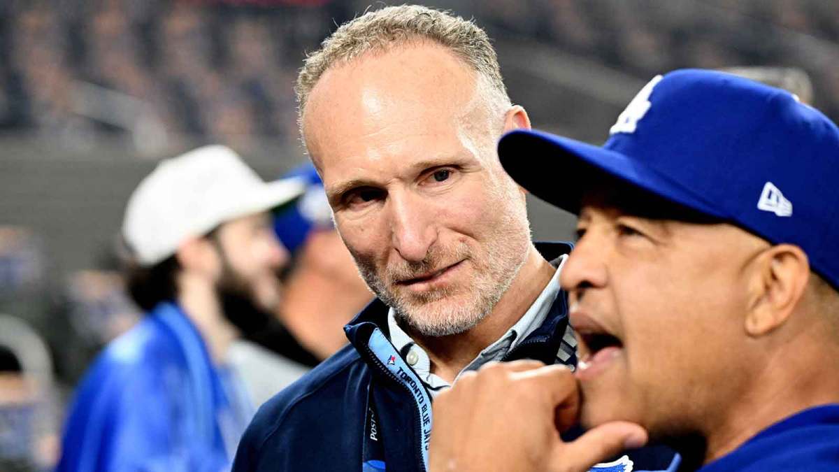 Toronto Blue Jays president Mark Shapiro speaks with Los Angeles Dodgers manager Dave Roberts (30) before game six of the 2025 MLB World Series at Rogers Centre.