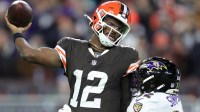 Cleveland Browns quarterback Shedeur Sanders (12) is hit by Baltimore Ravens linebacker Trenton Simpson (32) during the second half of an NFL football game at Huntington Bank Field, Nov. 16, 2025, in Cleveland, Ohio.