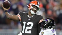 Cleveland Browns quarterback Shedeur Sanders (12) is hit by Baltimore Ravens linebacker Trenton Simpson (32) during the second half of an NFL football game