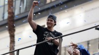 Los Angeles Dodgers two-way player Shohei Ohtani acknowledges the crowd during the World Series championship parade at downtown Los Angeles.