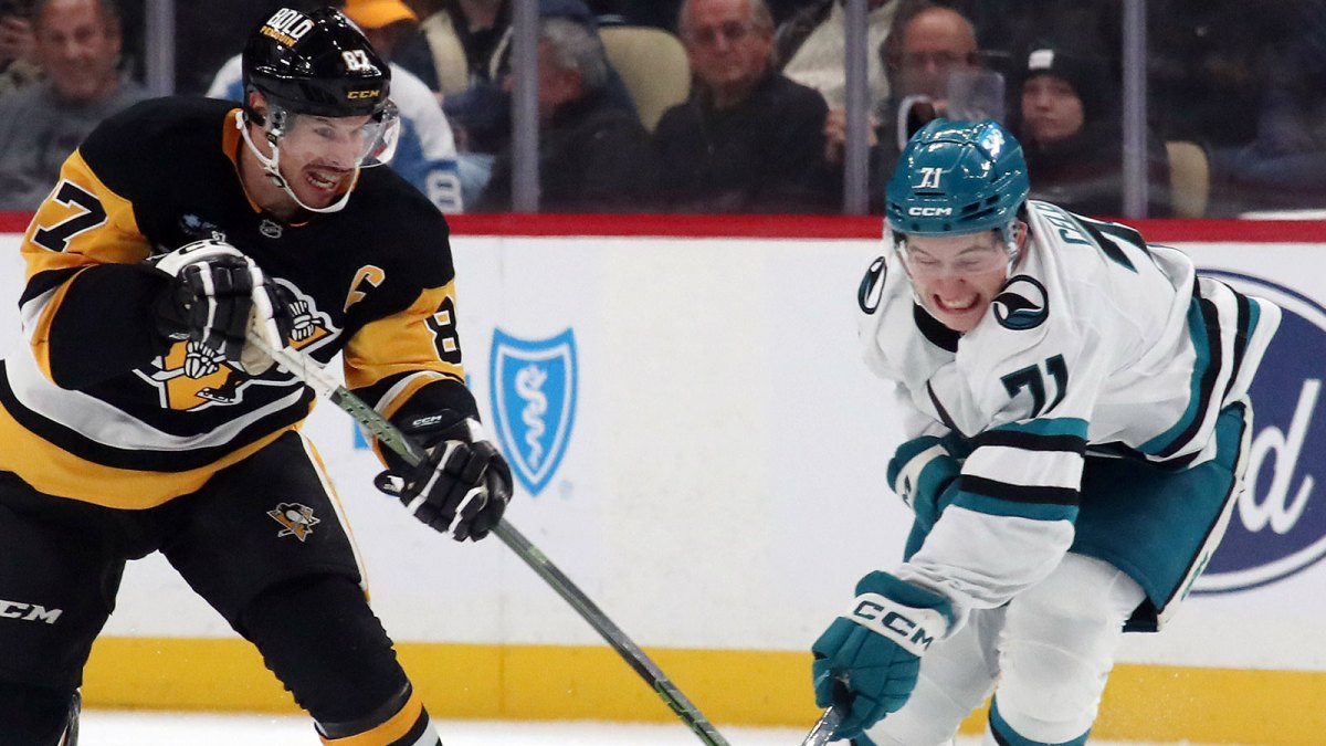 Pittsburgh Penguins center Sidney Crosby (87) and San Jose Sharks center Macklin Celebrini (71) battle to control the puck during the third period at PPG Paints Arena.