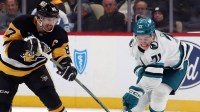 Pittsburgh Penguins center Sidney Crosby (87) and San Jose Sharks center Macklin Celebrini (71) battle to control the puck during the third period at PPG Paints Arena.